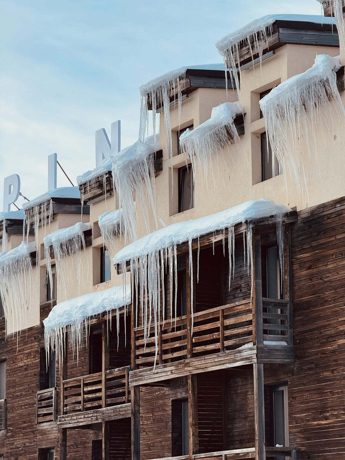 Building with icicles hanging from the roof in winter